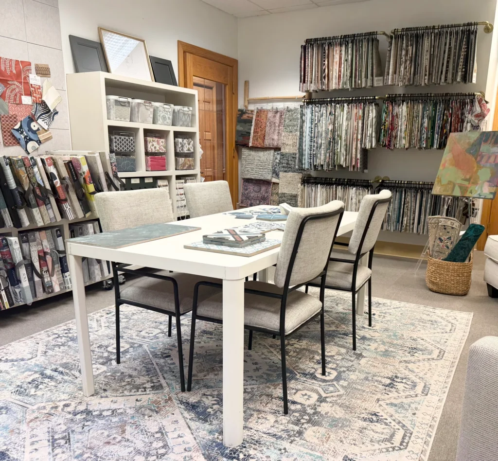 Hayden Home Studio's Charlotte design studio with a consultation table, fabric samples, and wallpaper books